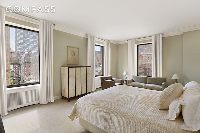 435 E 52nd St Unit 11A, New York City, NY 10022 - carpeted bedroom with radiator, ornamental molding, and baseboards