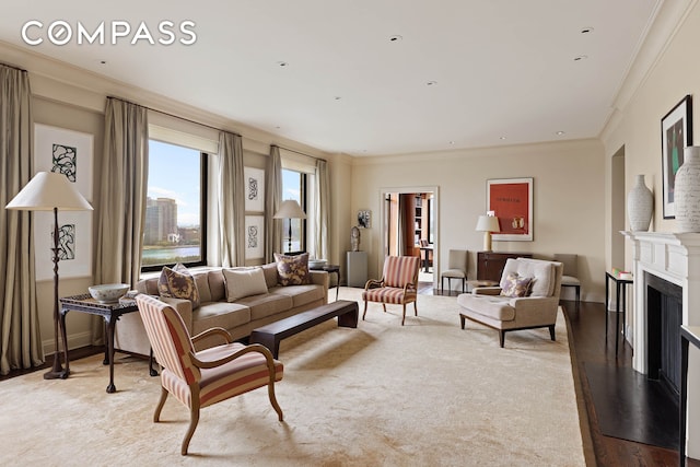 living area with crown molding, baseboards, light wood-style flooring, recessed lighting, and a fireplace