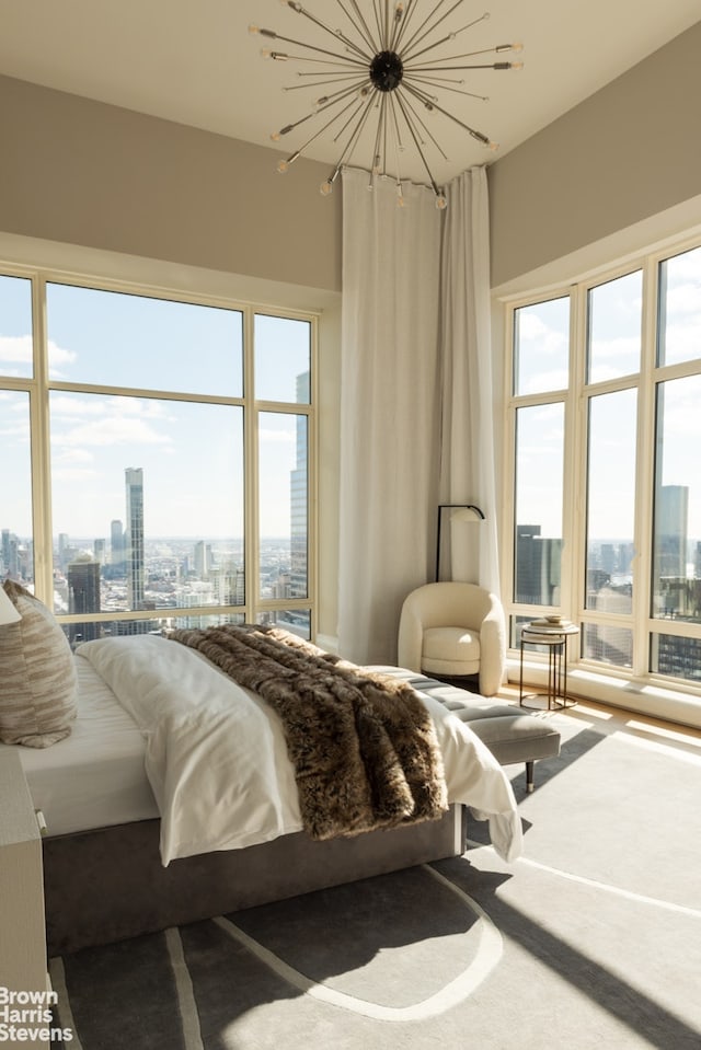 bedroom with a city view and multiple windows