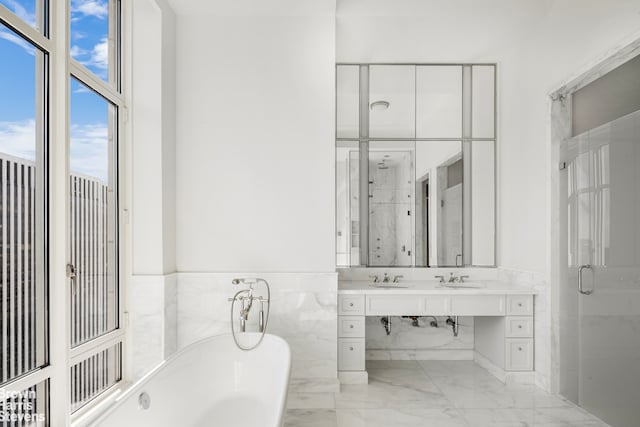 bathroom featuring a freestanding bath, vanity, a stall shower, marble finish floor, and tile walls