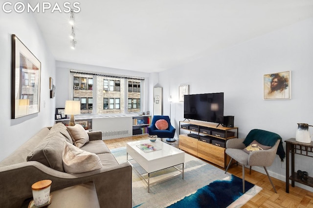 living room featuring rail lighting and parquet flooring