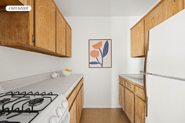 kitchen featuring sink and white appliances