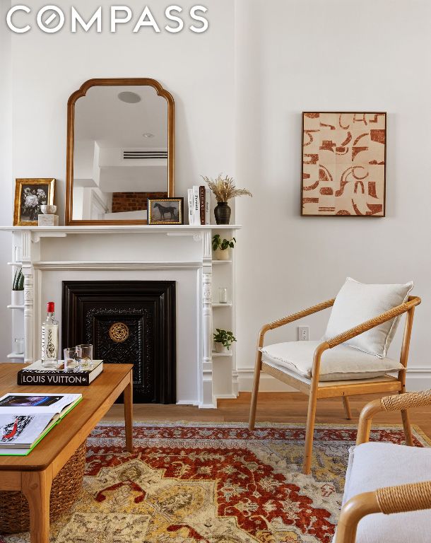 sitting room with hardwood / wood-style flooring