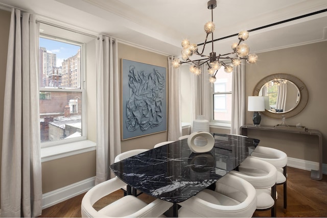 dining area with a chandelier, baseboards, and crown molding
