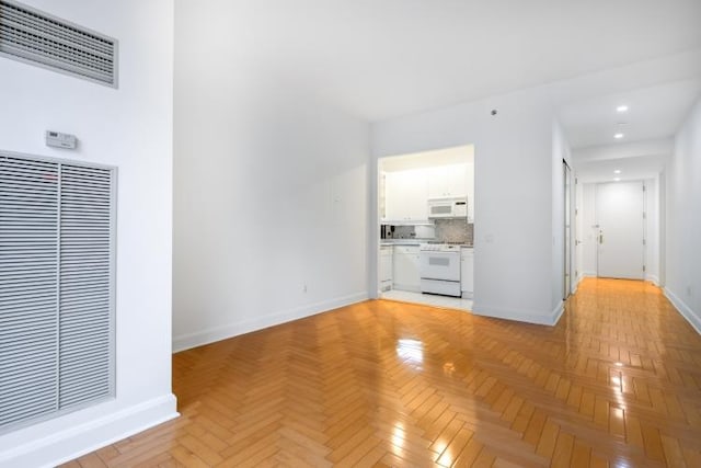 unfurnished living room featuring light parquet flooring