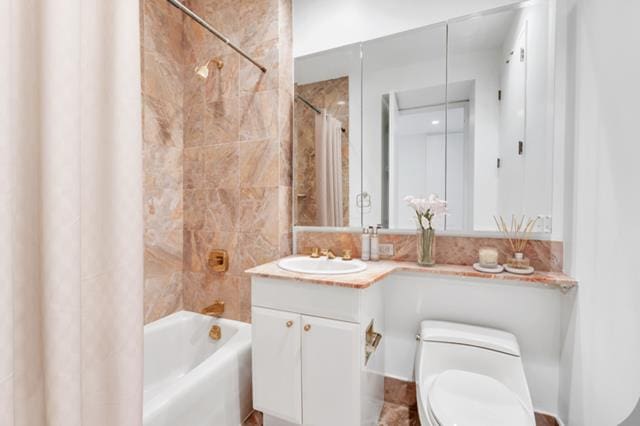 full bathroom with vanity, toilet, and shower / tub combo