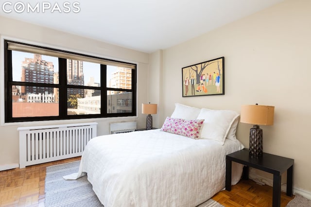 bedroom with parquet flooring and radiator