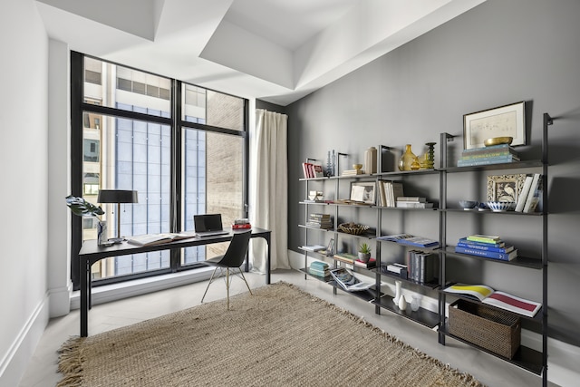 office space featuring baseboards and floor to ceiling windows