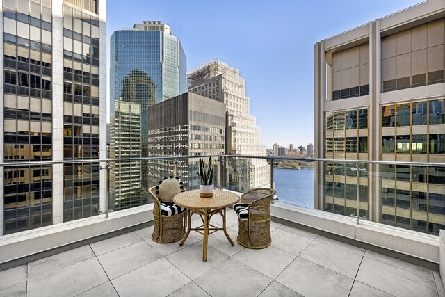 balcony featuring a view of city and a water view