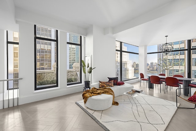 living area featuring a wealth of natural light, a view of city, and a chandelier