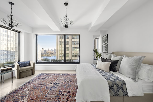 bedroom with a chandelier, a city view, a water view, and wood finished floors