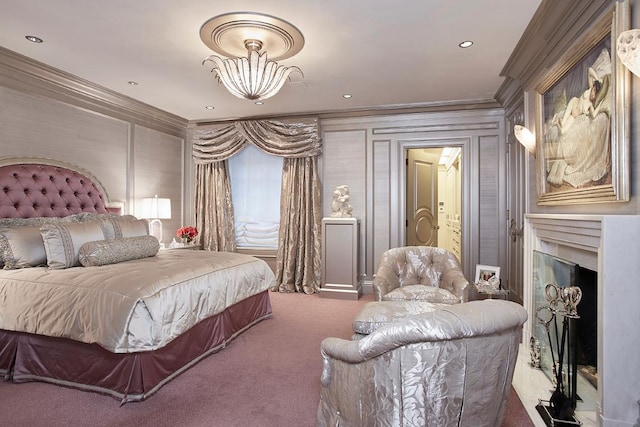 carpeted bedroom featuring an inviting chandelier, a high end fireplace, and ornamental molding