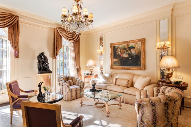 living area featuring an inviting chandelier and ornamental molding