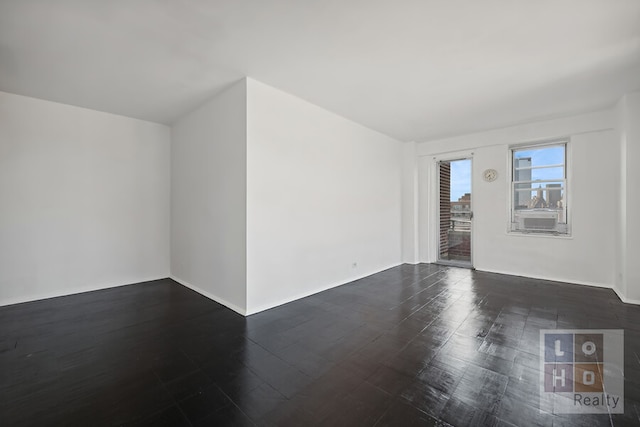 unfurnished room featuring dark wood finished floors