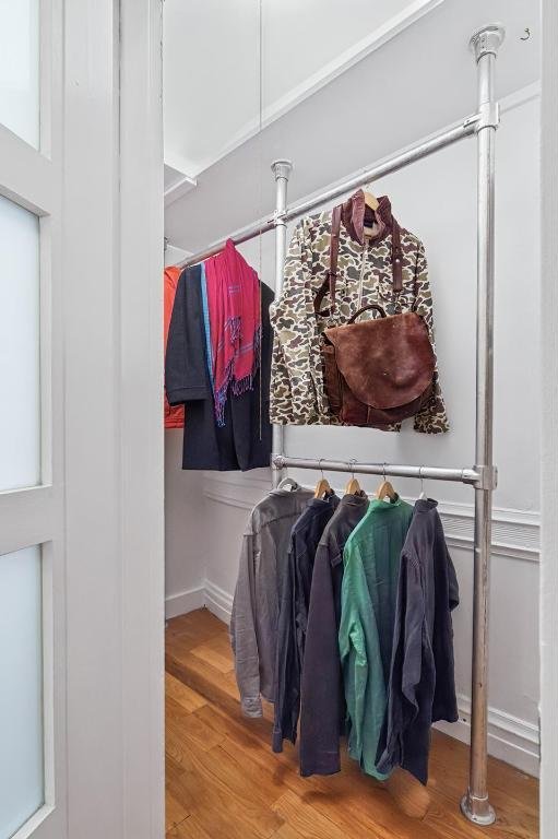 walk in closet with hardwood / wood-style flooring