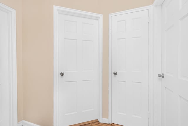 interior space with baseboards and light wood finished floors