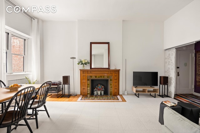 living area with a tiled fireplace