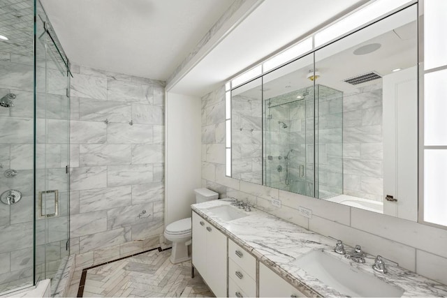 bathroom featuring tile walls, vanity, a shower with door, and toilet