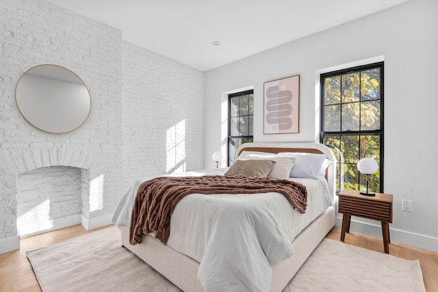 bedroom featuring multiple windows and hardwood / wood-style flooring