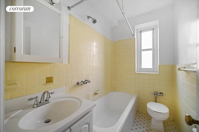 full bathroom with tile patterned flooring, vanity, shower / bath combination, tile walls, and toilet