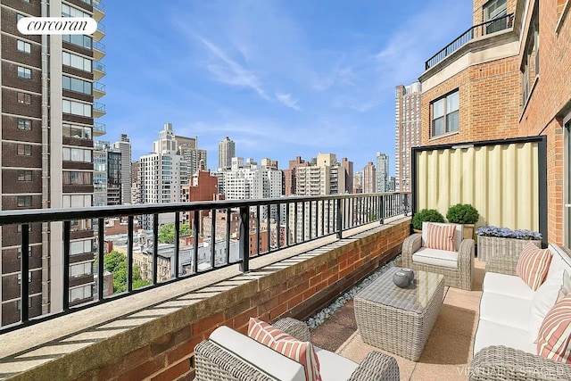 balcony with an outdoor hangout area and a city view