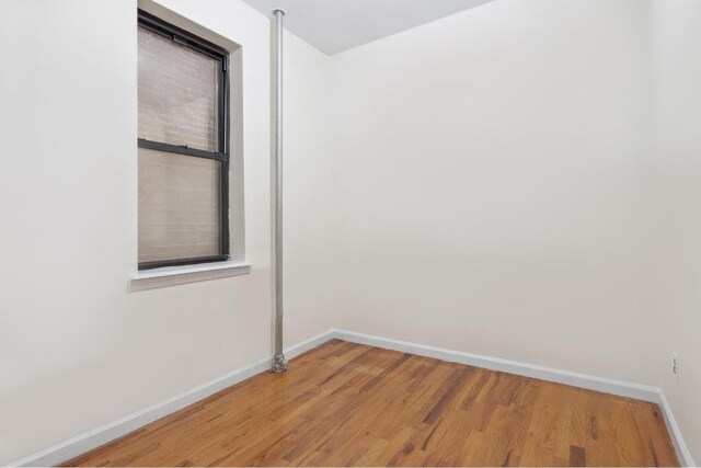 spare room with hardwood / wood-style floors