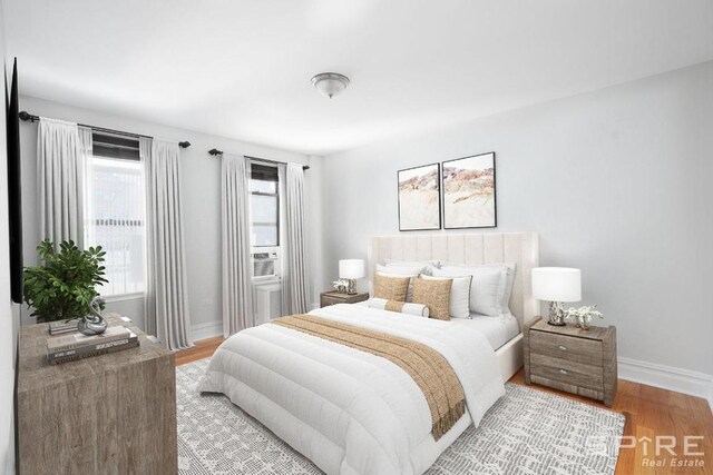 bedroom with baseboards and light wood-style floors