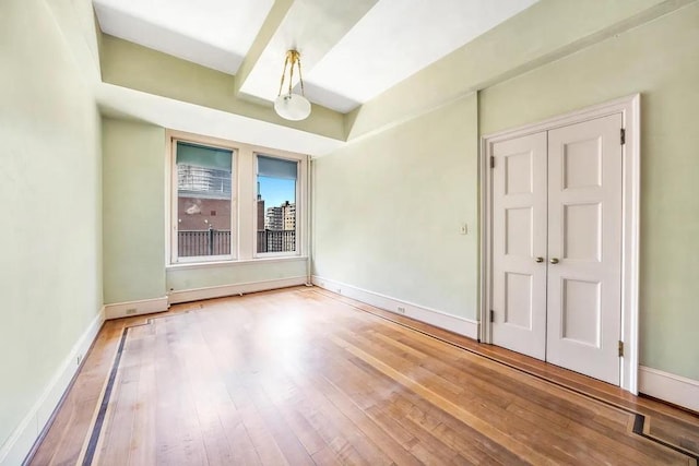 unfurnished room featuring hardwood / wood-style flooring