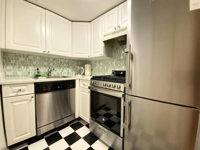 kitchen featuring sink, white cabinetry, appliances with stainless steel finishes, and tasteful backsplash