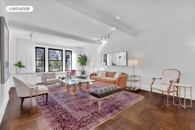 living room featuring rail lighting, beam ceiling, and dark parquet floors