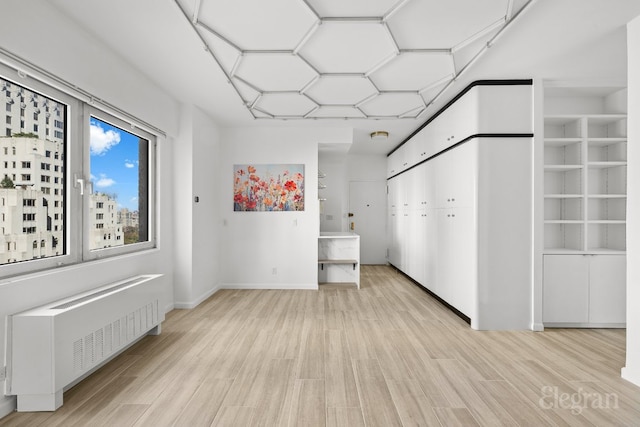 interior space with radiator and light wood-type flooring