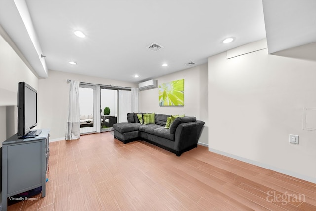 living room with hardwood / wood-style flooring and a wall mounted AC