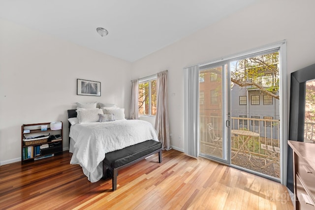 bedroom featuring hardwood / wood-style floors and access to outside