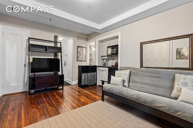 living room with dark hardwood / wood-style flooring