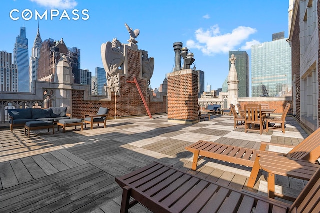 wooden deck featuring a view of city and an outdoor living space