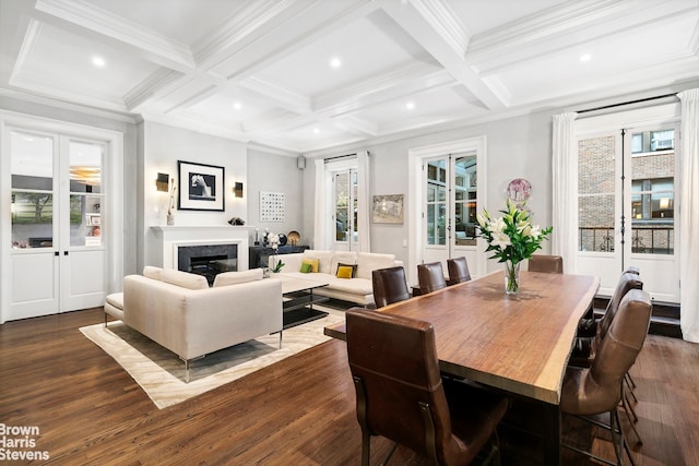 dining space with dark hardwood / wood-style floors, ornamental molding, beamed ceiling, and coffered ceiling