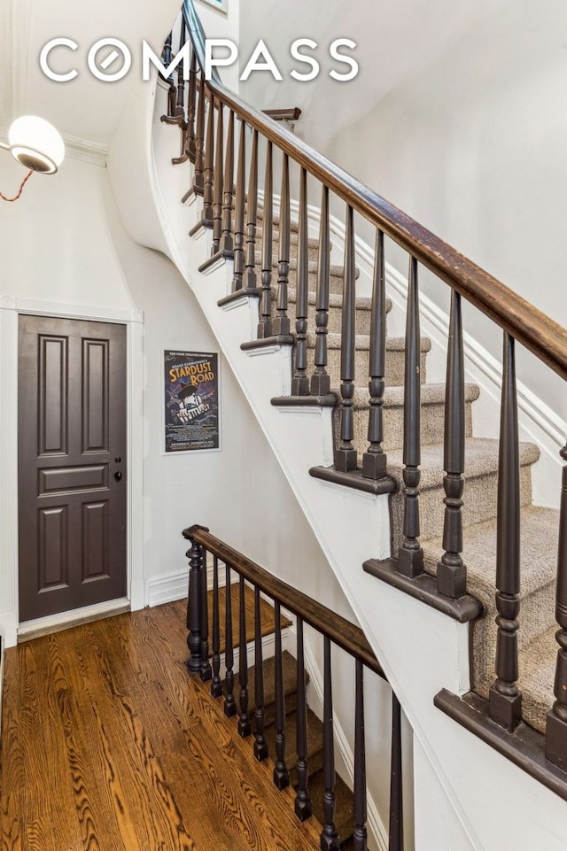 staircase with wood finished floors