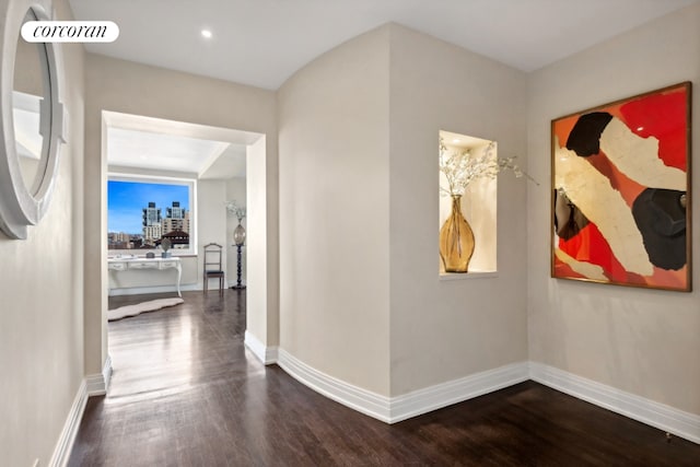 corridor with hardwood / wood-style floors