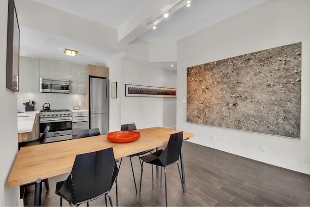 dining space featuring dark wood-style flooring and track lighting