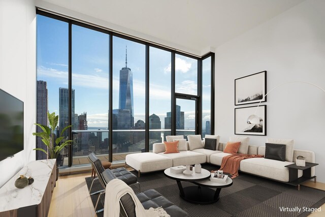 living room featuring light hardwood / wood-style flooring and a wall of windows