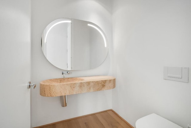 bathroom with wood-type flooring and toilet