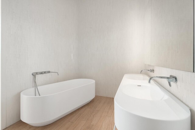 bathroom featuring tile walls, toilet, and tiled shower / bath