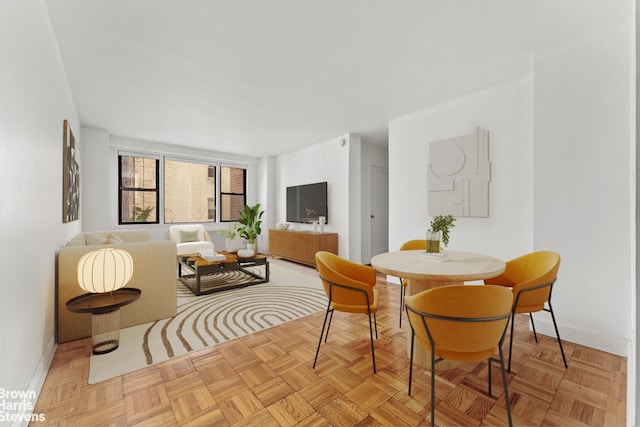 dining space featuring light parquet floors