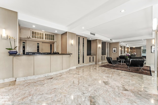 kitchen with recessed lighting, marble finish floor, visible vents, and a tray ceiling