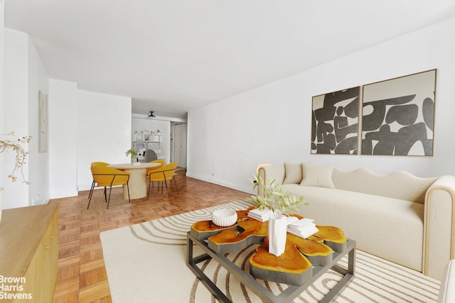 living room featuring ceiling fan and light parquet flooring