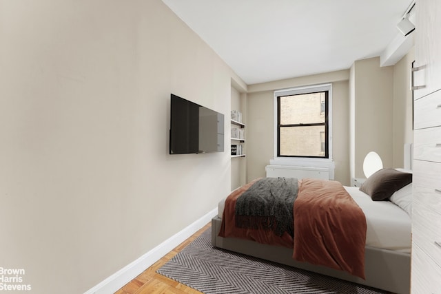 bedroom with parquet flooring