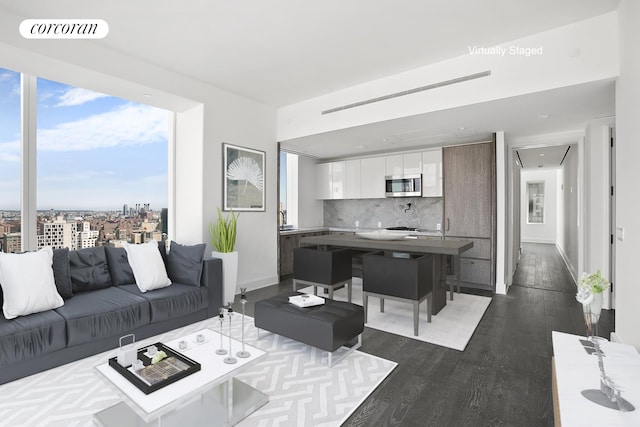 living area featuring dark wood finished floors and baseboards