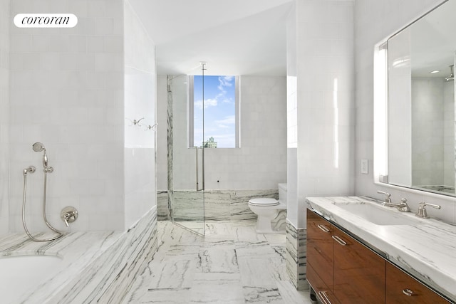 bathroom featuring a marble finish shower, vanity, toilet, marble finish floors, and a bath