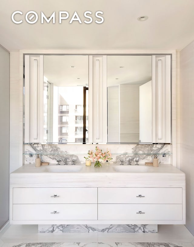 bathroom with double vanity, tasteful backsplash, and a sink