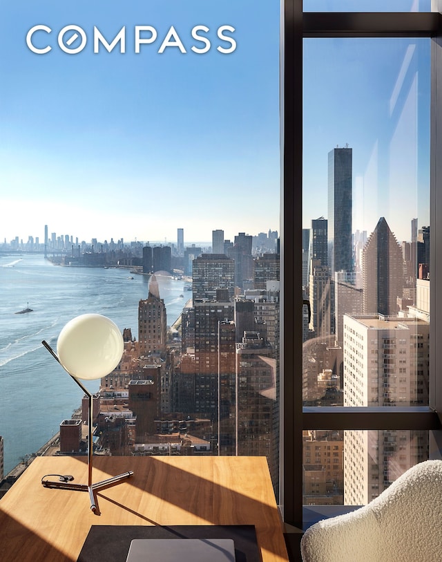 interior space featuring a city view and a water view